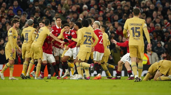 Manchester United and Barcelona players scuffle during the Europa League playoff second leg soccer match between Manchester United and Barcelona at Old Trafford stadium in Manchester, England, Thursday, Feb. 23, 2023. (AP Photo/Dave Thompson)