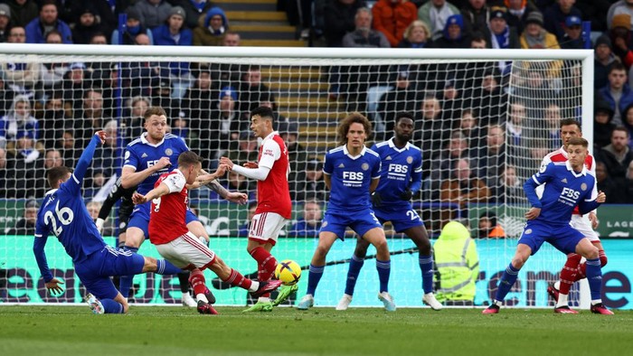 Arsenals Belgian midfielder Leandro Trossard scores his teams first goal, which is later ruled out after a VAR review, during the English Premier League football match between Leicester City and Arsenal at King Power Stadium in Leicester, central England on February 25, 2023. (Photo by Darren Staples / AFP) / RESTRICTED TO EDITORIAL USE. No use with unauthorized audio, video, data, fixture lists, club/league logos or live services. Online in-match use limited to 120 images. An additional 40 images may be used in extra time. No video emulation. Social media in-match use limited to 120 images. An additional 40 images may be used in extra time. No use in betting publications, games or single club/league/player publications. /  (Photo by DARREN STAPLES/AFP via Getty Images)