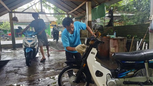 WBP Rutan Negara saat mencuci sepeda motor milik pelanggan di area depan Rutan Kelas II B Negara, Kecamatan Negara, Jembrana, Bali, Minggu (26/2/2023).