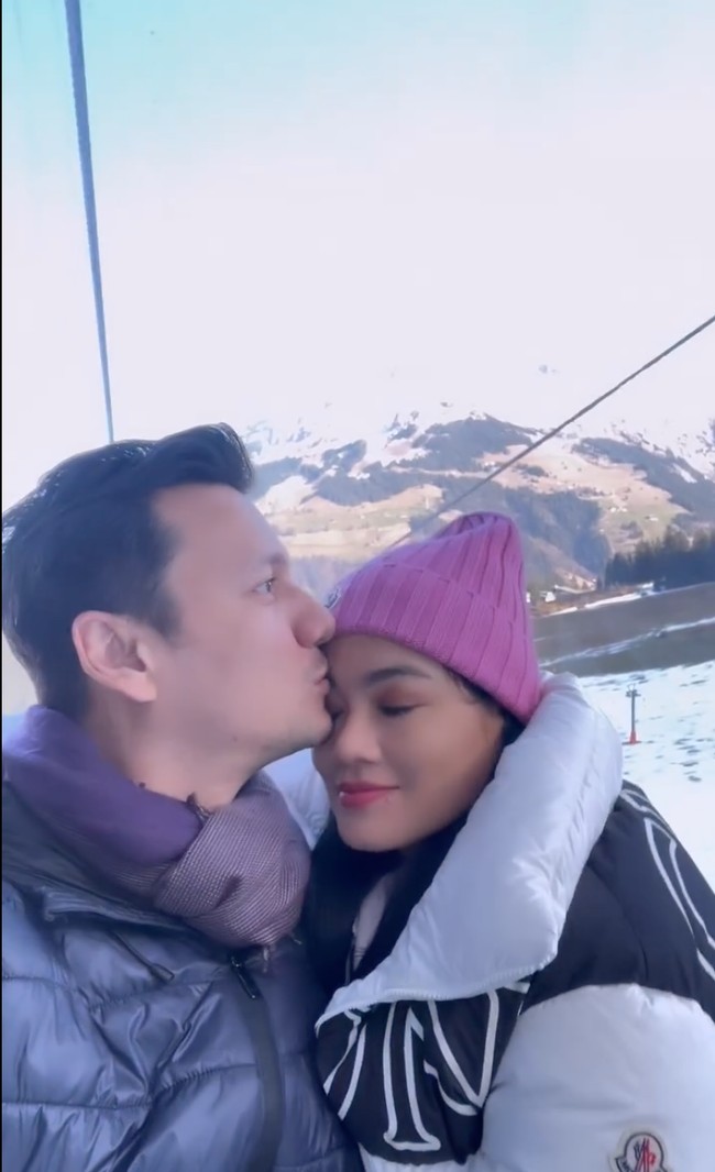 Berpose di Swiss yang sedang bersalju, keduanya tampak begitu lengket seolah tak terpisahkan. Christian Sugiono juga tampak mencium kening sang istri dengan mesra. Foto: Instagram/@titi_kamall