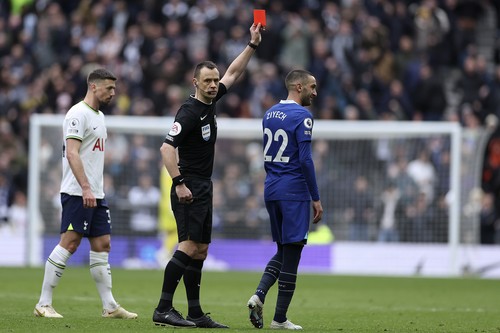 Referee Stuart Attwell shows the red card to Chelseas Hakim Ziyech, right, during the English Premier League soccer match between Tottenham Hotspur and Chelsea at Tottenham Hotspur Stadium in London, Sunday, Feb. 26, 2023.(AP Photo/Ian Walton)