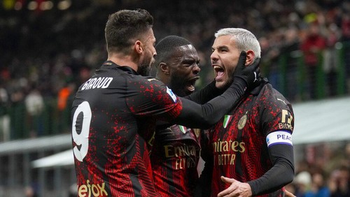 AC Milans Theo Hernandez, right, celebrates with his teammates after he scored his sides first goal during a Serie A soccer match between AC Milan and Atalanta, at Milans San Siro Stadium, Sunday, Feb. 26, 2023. (AP Photo/Antonio Calanni)