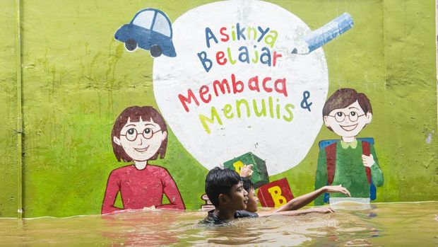 Sejumlah bocah bermain saat banjir merendam kawasan pemukiman penduduk, Kebon Pala, Jakarta, Senin (27/2/2023). Intensitas hujan tinggi di wilayah DKI Jakarta dan luapan Kali Ciliwung mengakibatkan sejumlah permukiman warga terendam banjir diantaranya Kelurahan Tegal Alur, Kelurahan Rawa Buaya dan Kelurahan Kampung Melayu. ANTARA FOTO/Muhammad Adimaja/hp.
