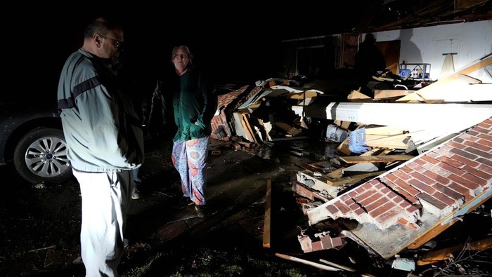 Stephen Buckner, left, and his wife Barbara Buckner look over their home that was destroyed by a tornado in Norman, Oklahoma, U.S. February 27, 2023. REUTERS/Nick Oxford
