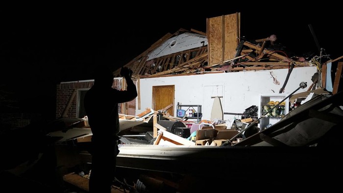Stephen Buckner, left, and his wife Barbara Buckner look over their home that was destroyed by a tornado in Norman, Oklahoma, U.S. February 27, 2023. REUTERS/Nick Oxford
