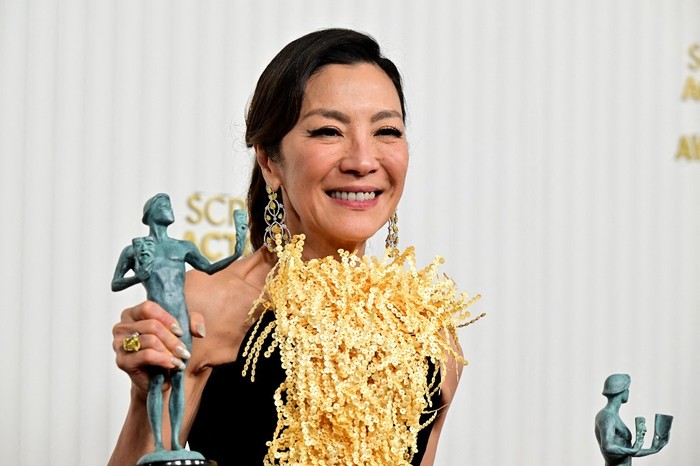 Malaysian actress Michelle Yeoh poses with the awards for Outstanding Performance by a Female Actor in a Leading Role and Outstanding Performance by a Cast in a Motion Picture 