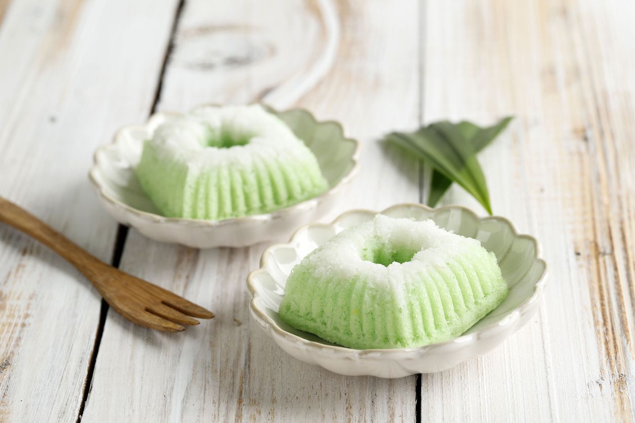 Kue Putu Ayu, Indonesian Traditional Jajan pasar made from Steamed Flour and Grated Coconut. On White Wooden Background