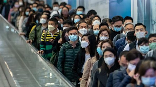 Passengers at Central station, operated by MTR Corp., in Hong Kong, China, on Tuesday, Feb. 28, 2023. Hong Kong will stop requiring masks to be worn in public places from Wednesday, drawing to a close the prolonged Covid era that damaged its economy and standing in the world. Photographer: Paul Yeung/Bloomberg via Getty Images
