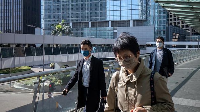 Passengers at Central station, operated by MTR Corp., in Hong Kong, China, on Tuesday, Feb. 28, 2023. Hong Kong will stop requiring masks to be worn in public places from Wednesday, drawing to a close the prolonged Covid era that damaged its economy and standing in the world. Photographer: Paul Yeung/Bloomberg via Getty Images