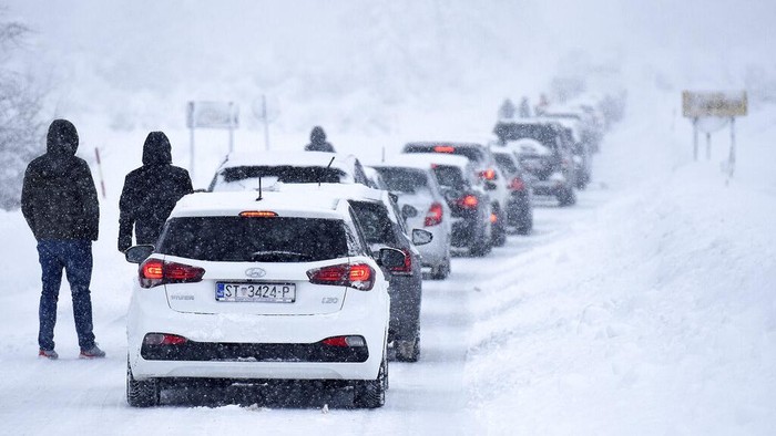 Motorists blocked by snow wait to continue their journeys, near Gospic, Croatia, Monday, Feb. 27, 2023. Hundreds of people in Croatia have spent the night in their cars or in cafes and reception centers after a snow storm on weekend caused a traffic collapse and left parts of the country cut off. (AP Photo)