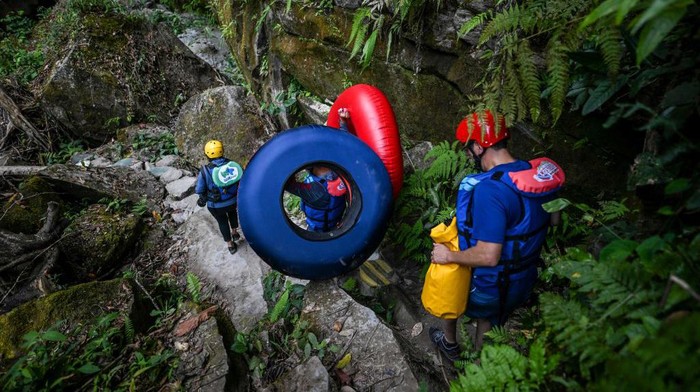 Tourists ride inflatables to cross the Guape canyon in La Uribe municipality in the Meta Department, Colombia, on February 19, 2022. - The Guape Canyon, a 35-metre-deep natural wonder, which served as a route for guerrillas in Colombia, was rediscovered thanks to the 2016 peace agreement with the Revolutionary Armed Forces of Colombia (FARC). (Photo by Juan BARRETO / AFP) (Photo by JUAN BARRETO/AFP via Getty Images)