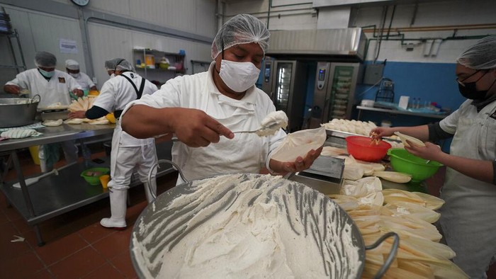 Workers make tamales for the 