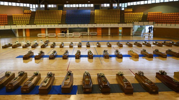 Victims of a migrants boat shipwreck lay in state in a sports centre where they were taken, in Crotone, southern Italy, Tuesday, Feb. 28, 2023. Rescue crews searched by sea and air for the dozens of people believed still missing from a shipwreck off Italy's southern coast that drove home once again the desperate and dangerous crossings of migrants seeking to reach Europe. (AP Photo/Valeria Ferraro)