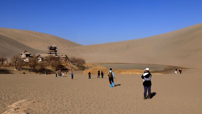 DUNHUANG, CHINA - MARCH 01: General view of the Mingsha Mountain and Crescent Spring scenic spot on March 1, 2023 in Dunhuang, Jiuquan City, Gansu Province of China. (Photo by Zhang Xiaoliang/VCG via Getty Images)