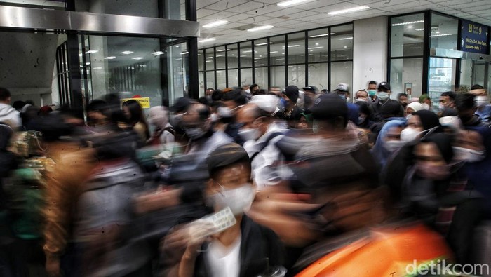 Ratusan penumpang berusaha masuk ke dalam transportasi umum KRL di Stasiun Manggarai, Rabu (22/2/2023).