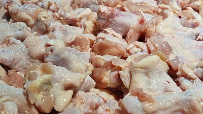 parts of raw chicken meat on ice for sell in a supermarket in Thailand.