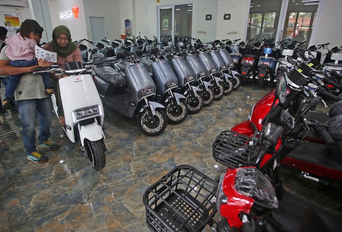 Calon pembeli didampingi tenaga penjual melihat motor listrik yang di jual di showroom motor listrik  Tangkas Ciater, Tangerang Selatan, Banten, Senin (6/3/2023). Pemerintah mulai 20 Maret 2023 memberikan subsidi kendaraan listrik, demi meningkatkan keterjangkauan harga dan daya beli masyarakat terhadap kendaraan listrik, serta memacu perkembangan industri otomotif energi baru. ANTARA FOTO/Muhammad Iqbal/hp.