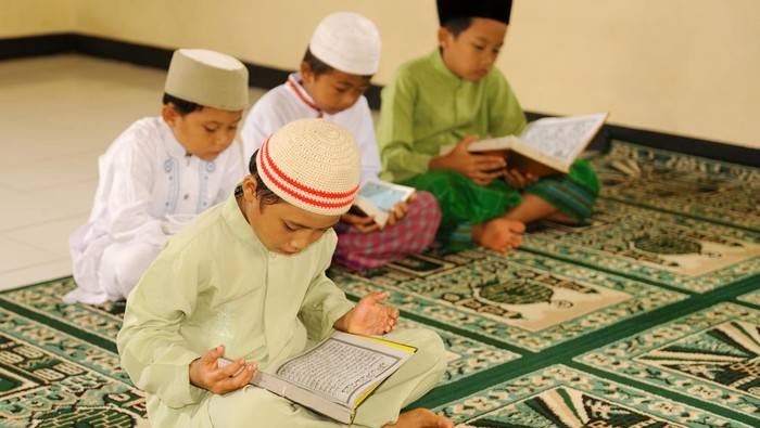 Muslim kids reciting holy Koran