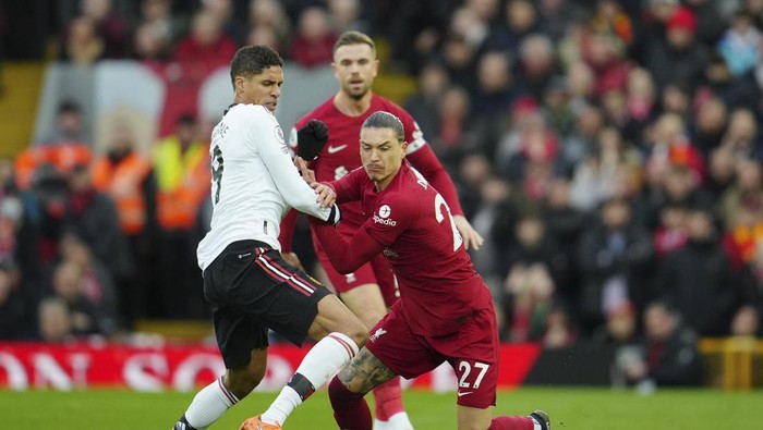 Manchester Uniteds Raphael Varane, left, challenges Liverpools Darwin Nunez during the English Premier League soccer match between Liverpool and Manchester United at Anfield in Liverpool, England, Sunday, March 5, 2023. (AP Photo/Jon Super)