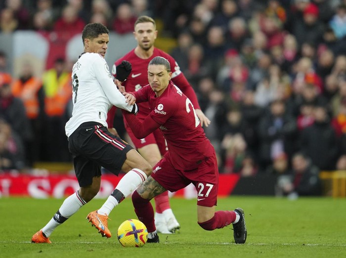 Manchester Uniteds Raphael Varane, left, challenges Liverpools Darwin Nunez during the English Premier League soccer match between Liverpool and Manchester United at Anfield in Liverpool, England, Sunday, March 5, 2023. (AP Photo/Jon Super)