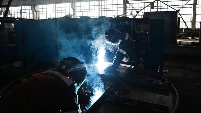 Workers weld and cut metal as they build a shelter in a plant of Metinvest company, in Kryvyi Rih, Ukraine, Thursday, March 2, 2023. The plant, which is part of Renat Akhmetov's Metinvest metals and mining holding, ships metal shelters to frontline. (AP Photo/Thibault Camus)