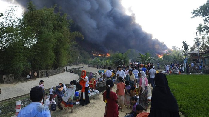 Rohingya refugees try to salvage their belongings after a major fire in their Balukhali camp at Ukhiya in Cox's Bazar district, Bangladesh, Sunday, March 5, 2023. A massive fire raced through a crammed camp of Rohingya refugees in southern Bangladesh on Sunday, leaving thousands homeless, a fire official and the United Nations said. (AP Photo/Mahmud Hossain Opu)