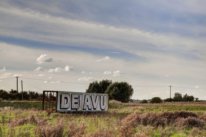 A billboard in a field with the words dejavu printed in large letters