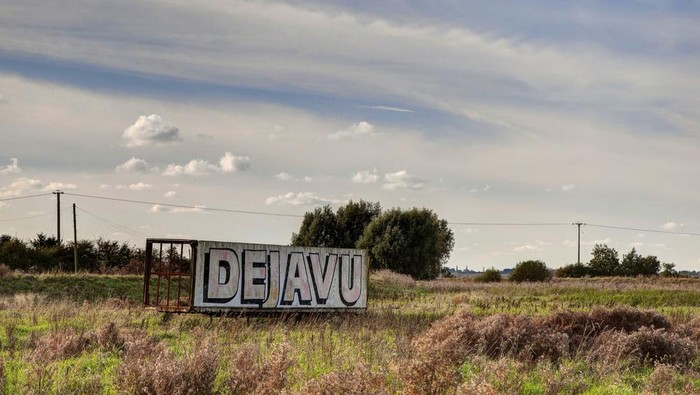 A billboard in a field with the words dejavu printed in large letters