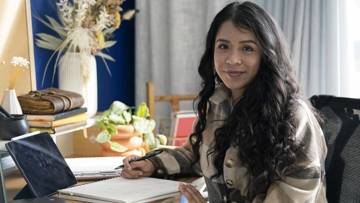 A custom signature created by Priscilla Molina, left, appears next to images of original client signatures and initials on a cell phone in Los Angeles on Feb. 22, 2023. Molina designs a minimum of 300 custom signatures a month, offering packages that include up to three ways to sign, limitless drafts or a new set of initials.