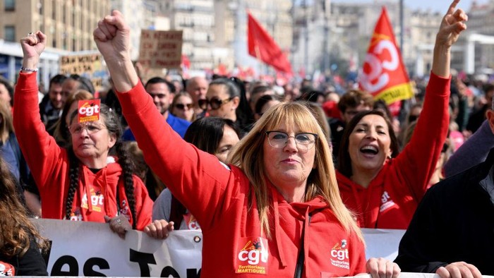 TOPSHOT - CGT unionists take part in a demonstration on the Vieux Port (Old Harbour) in Marseille on March 7, 2023, as part of a nationwide day of strikes and protests called by unions over the proposed pensions overhaul, which include raising the minimum retirement age to 64 from 62 and increasing the number of years people have to make contributions for a full pension. (Photo by NICOLAS TUCAT / AFP) (Photo by NICOLAS TUCAT/AFP via Getty Images)
