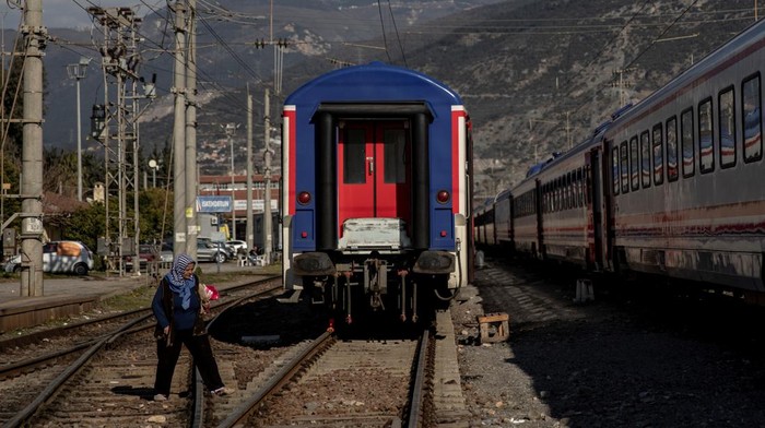 A woman walks on the tracks at Iskenderun train station, where train carriages have been turned into temporary shelters for victims of the recent deadly earthquake, in Iskenderun, Turkey, February 15, 2023. Turkish authorities have been racing to find accommodation for the more than 1.5 million people left homeless after February's huge earthquakes, which killed some 50,000 people in Turkey and Syria. Survivors have been sheltering in tents, container homes, hotel resorts and even train carriages in Iskenderun, a port city in the province of Hatay, badly hit by the earthquakes. REUTERS/Eloisa Lopez SEARCH 