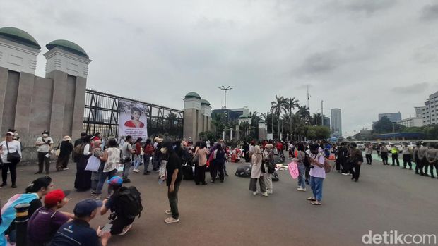 Sejumlah orang menggelar unjuk rasa mendesak pengesahan RUU PPRT di depan gedung DPR. Baliho bergambar wajah Ketua DPR Puan Maharani dibentangkan. (Ilham Oktafian/detikcom)
