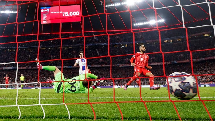 Bayern Munichs Cameroonian forward Eric Maxim Choupo-Moting (R) scores the opening goal past Paris Saint-Germains Italian goalkeeper Gianluigi Donnarumma during the UEFA Champions League round of 16, 2nd-leg football match FC Bayern Munich v Paris Saint-Germain FC in Munich, southern Germany, on March 8, 2023. (Photo by Odd ANDERSEN / AFP) (Photo by ODD ANDERSEN/AFP via Getty Images)