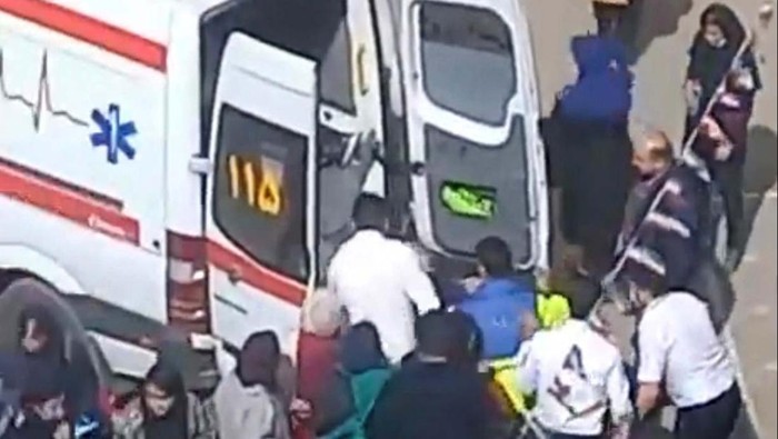 People gather around an ambulance outside a girls school after reports of poisoning in Fardis, Alborz province, Iran in this undated video still image released March 1, 2023 and obtained by REUTERS

ATTENTION EDITORS - THIS IMAGE HAS BEEN SUPPLIED BY A THIRD PARTY. NO RESALES. NO ARCHIVES.