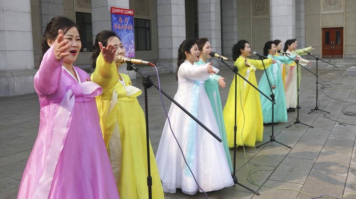 North Korea's art troupe performes in front of the Pyongyang Grand Threatre as they celebrate International Women's Day in Pyongyang, North Korea, Wednesday, March 8, 2023. (AP Photo/Jon Chol Jin)