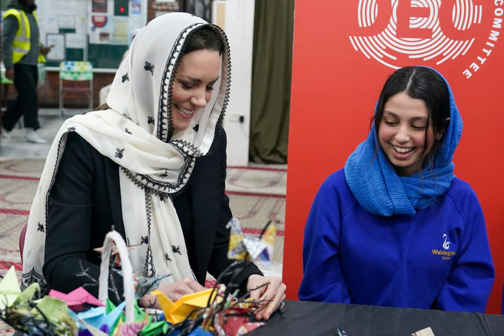 HAYES, ENGLAND - MARCH 09: Catherine, Princess of Wales makes paper cranes with Dila Kaya, 14, as she visits Hayes Muslim Centre on March 9, 2023 in Hayes, England. The Prince and Princess of Wales visited Hayes Muslim Centre and thanked those involved in the aid effort and those who have fundraised to help communities affected by the devastating earthquakes in Turkey and Syria. (Photo by Arthur Edwards - WPA Pool/Getty Images)