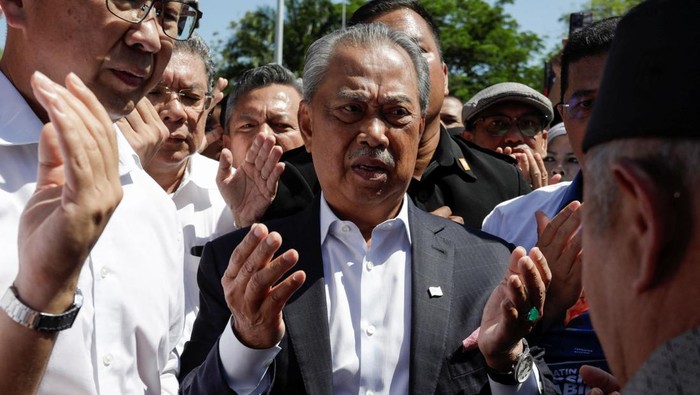 Images of former Malaysian Prime Minister Muhyiddin Yassin are seen on the shirt of his supporters at Kuala Lumpur Court Complex in Kuala Lumpur, Malaysia March 10, 2023. REUTERS/Hasnoor Hussain