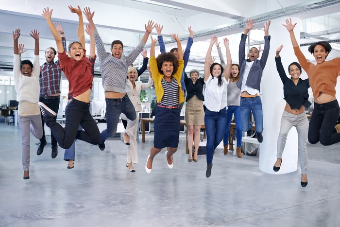 Shot of office staff jumping