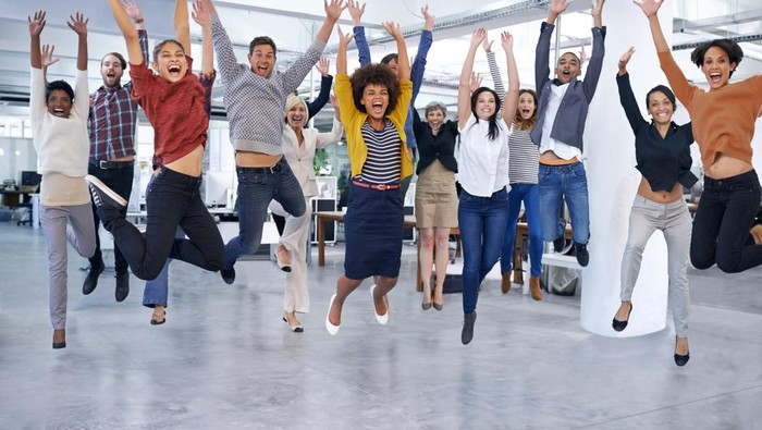 Shot of office staff jumping