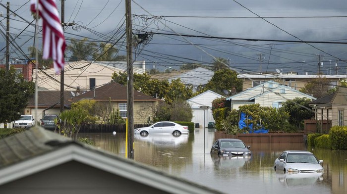 Cars are partially submerged in floodwaters in Watsonville, Calif., Saturday, March 11, 2023. (AP Photo/Nic Coury)