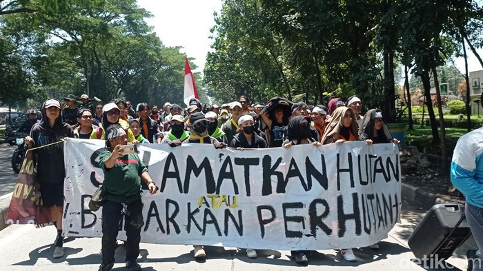 Demonstran di Kantor Perhutani Jabar membentangkan spanduk soal kerusakan alam di Ranca Upas