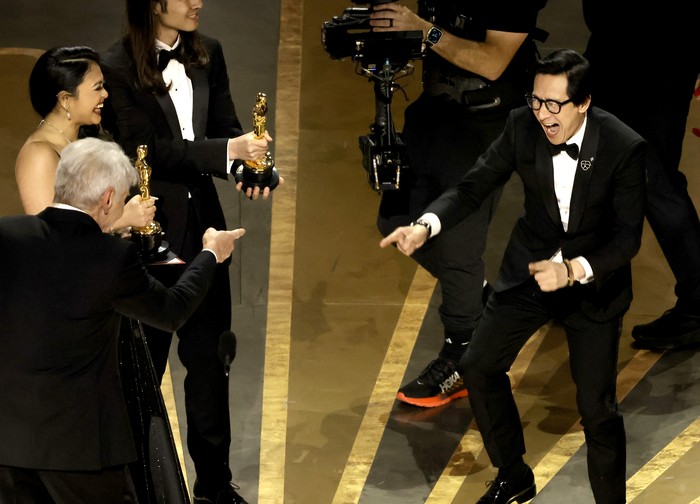 HOLLYWOOD, CALIFORNIA - MARCH 12:  Ke Huy Quan (R) accepts the award for Best Picture for 