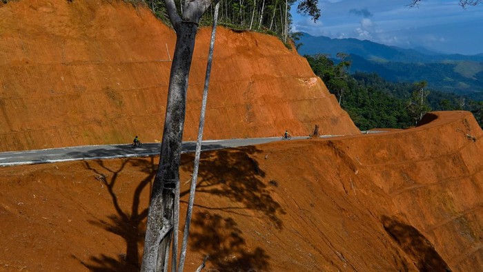 A motorist rides a newly constructed road seen on a mountain top in a protected forest are in Jantho, in Indonesia's Aceh province on March 12, 2023 (Photo by CHAIDEER MAHYUDDIN / AFP) (Photo by CHAIDEER MAHYUDDIN/AFP via Getty Images)