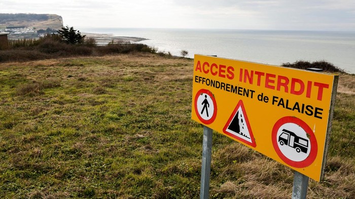 A view shows a road and houses near a part of cliff that crashed into the sea due to coastal erosion in Criel-sur-Mer, France, March 03, 2023. REUTERS/Pascal Rossignol