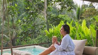 Sebelum mengunjungi Seoul, Wulan sempat berlibur di Ubud, Bali. Ia tampak menikmati secangkir kopi di tepi kolam renang dengan gaya santai. Foto: Instagram @wulanguritno