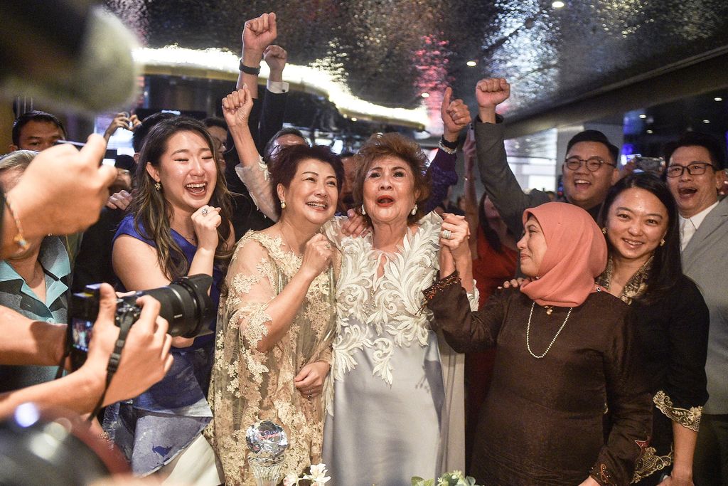 Janet Yeoh (centre R), mother of actress Michelle Yeoh, celebrates after her daughter won the award for Best Actress in a Leading Role at the 95th Academy Awards in Los Angeles, at an event in Kuala Lumpur on March 13, 2023. (Photo by Arif Kartono / AFP) (Photo by ARIF KARTONO/AFP via Getty Images)