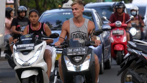 Turis asing mengendarai sepeda motor sewaan tanpa menggunakan helm di Jalan Pantai Kuta, Badung, Bali, Senin (13/3/2023). Gubernur Bali Wayan Koster mengimbau turis asing agar selalu mematuhi segala peraturan yang berlaku di Indonesia serta meminta menggunakan kendaraan yang disediakan oleh agen perjalanan dan tidak menggunakan kendaraan sendiri menyusul banyaknya turis asing yang ugal-ugalan mengendarai sepeda motor. ANTARA FOTO/Nyoman Hendra Wibowo/foc.