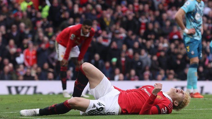 MANCHESTER, ENGLAND - MARCH 12: Alejandro Garnacho of Manchester United lies injured during the Premier League match between Manchester United and Southampton FC at Old Trafford on March 12, 2023 in Manchester, England. (Photo by Matthew Peters/Manchester United via Getty Images)