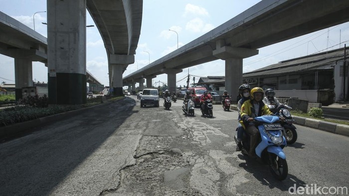 Hati-hati! Jalanan di Cakung Rusak Parah Pengendara melintas di jalan Raya Bekasi, Cakung, Jakarta Timur, Kamis (16/3/2023).