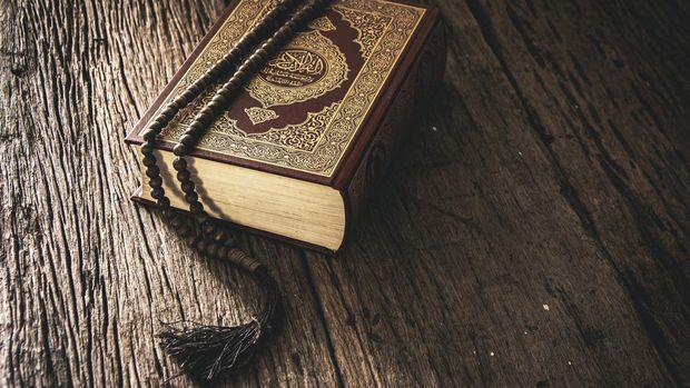 Koran - holy book of Muslims ( public item of all muslims ) on the table , still life .